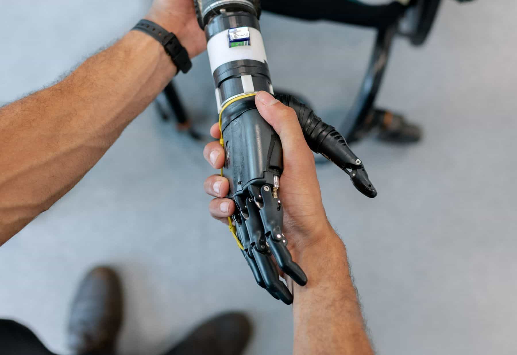 This image features shoes, footwears. Additional details include: machine, electrical cable, and tool. The image has dominant colors like grey, and black.